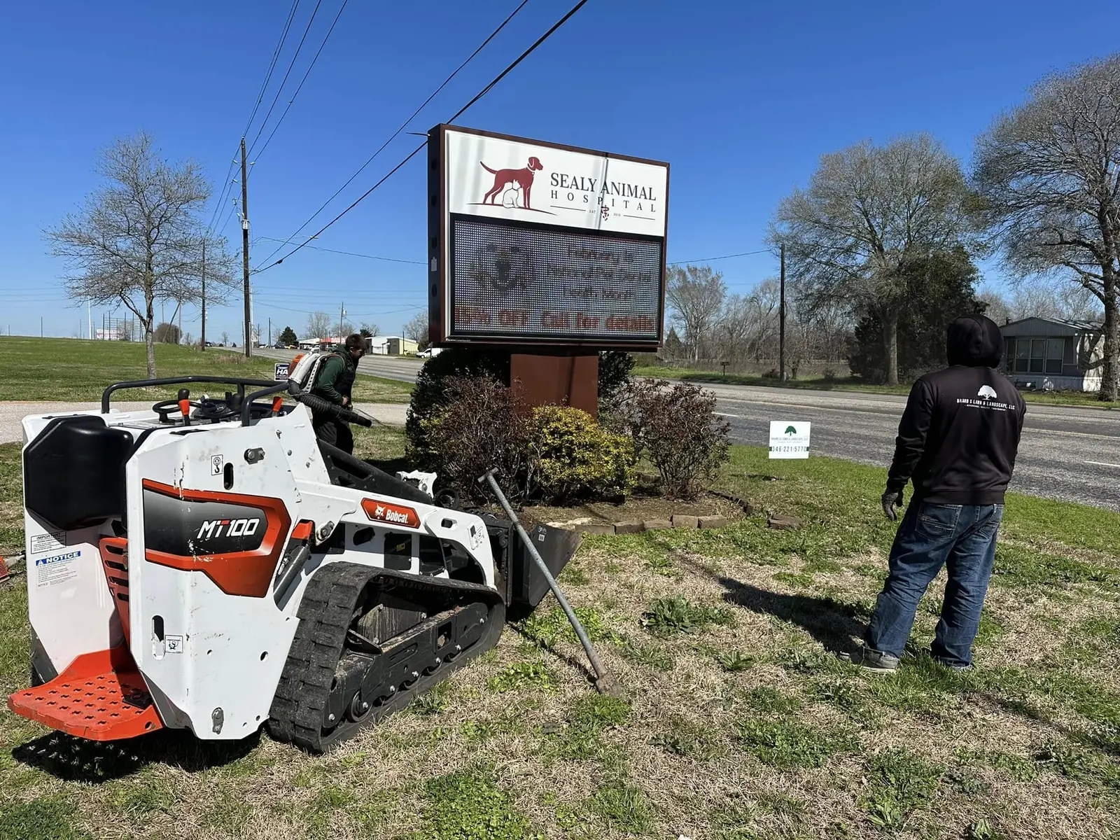 Commercial monument-sign landscape bed being cleared for improvements